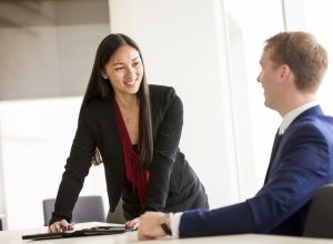 Professional woman and man at desk